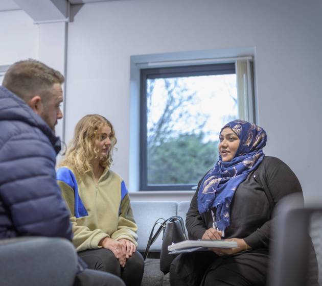 Foster care social worker in meeting with foster parents