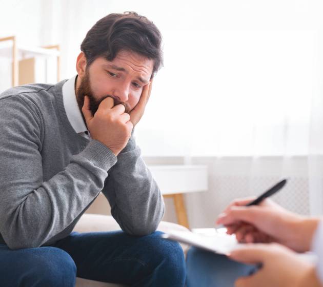 Man with depression during psychotherapy session, talking about his loneliness, free space