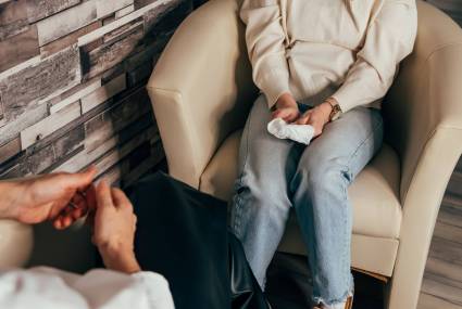 Psychologist counseling patient. Hands of man attending private psychologal therapy, doctor making notes while patient sharing his thoughts. Young female doctor in consultation with patient