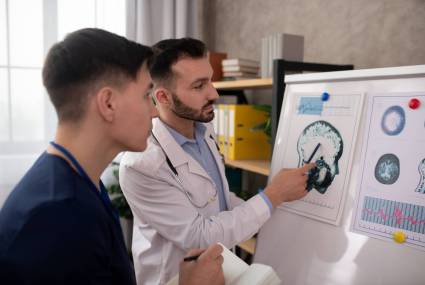 Sharing opinions. Two young neurologists looking concentrated while discussing the medical case