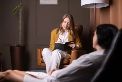 woman-in-therapy-session-taking-notes-indoors-2026-03-16-02-07-45-utc