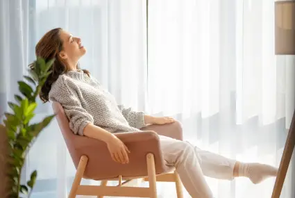 woman-relaxing-in-chair-by-sunny-window-2026-01-05-23-35-58-utc